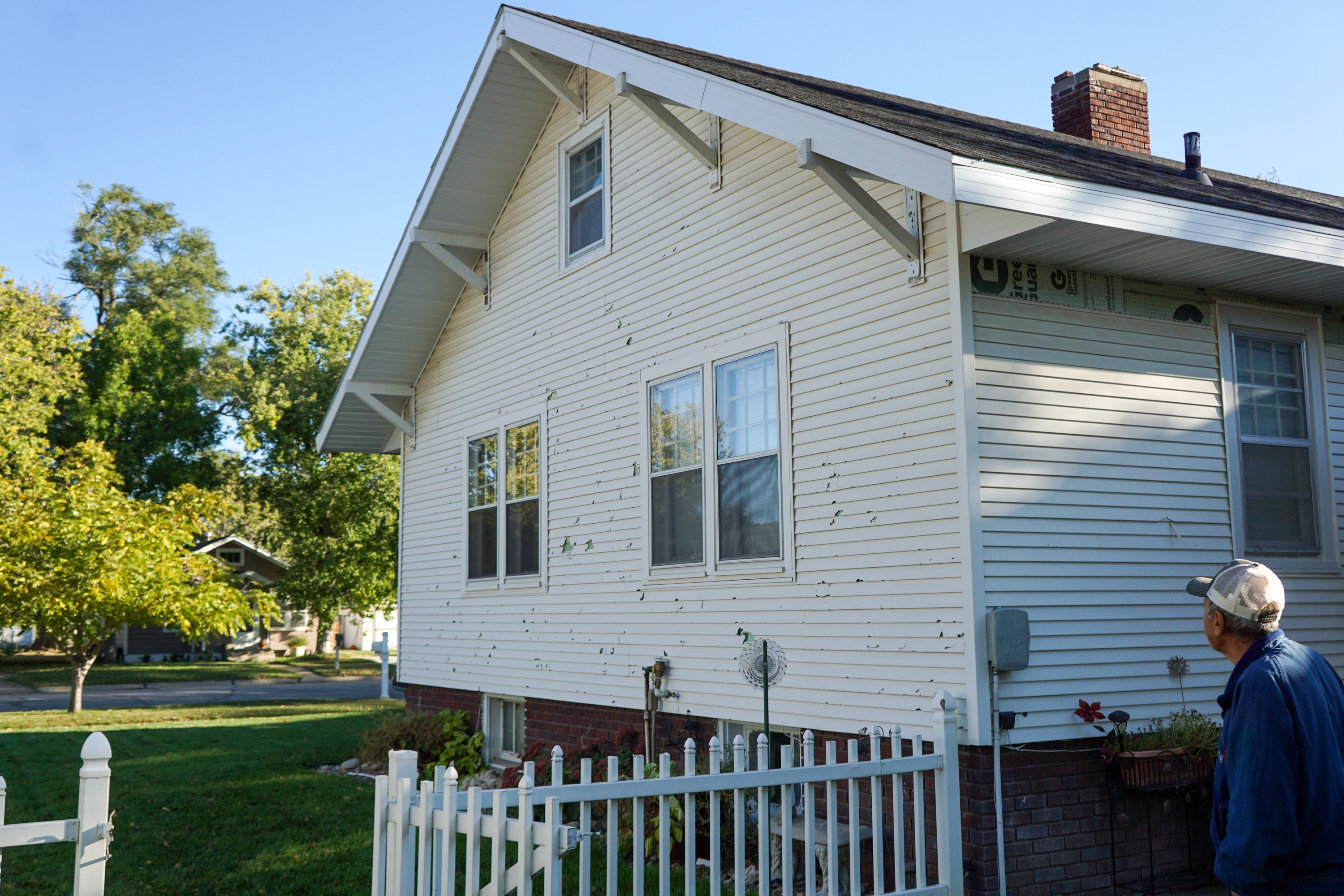 A hailstorm damaged virtually every building in the small town of Cozad, Neb. in June 2024. More than a year later, Baltazar Avalos is still working to fix damage to his home.